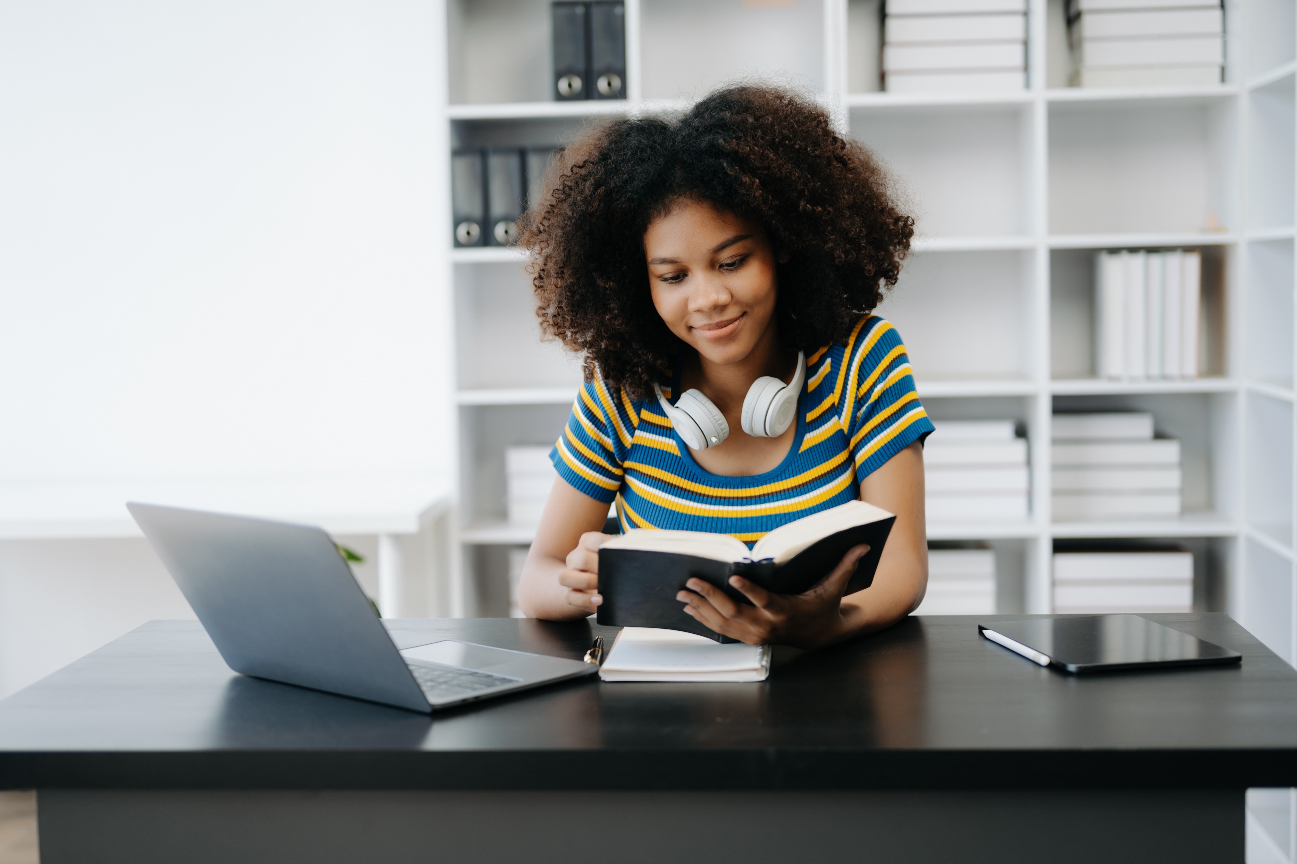 Female students note from the books at the African girl library